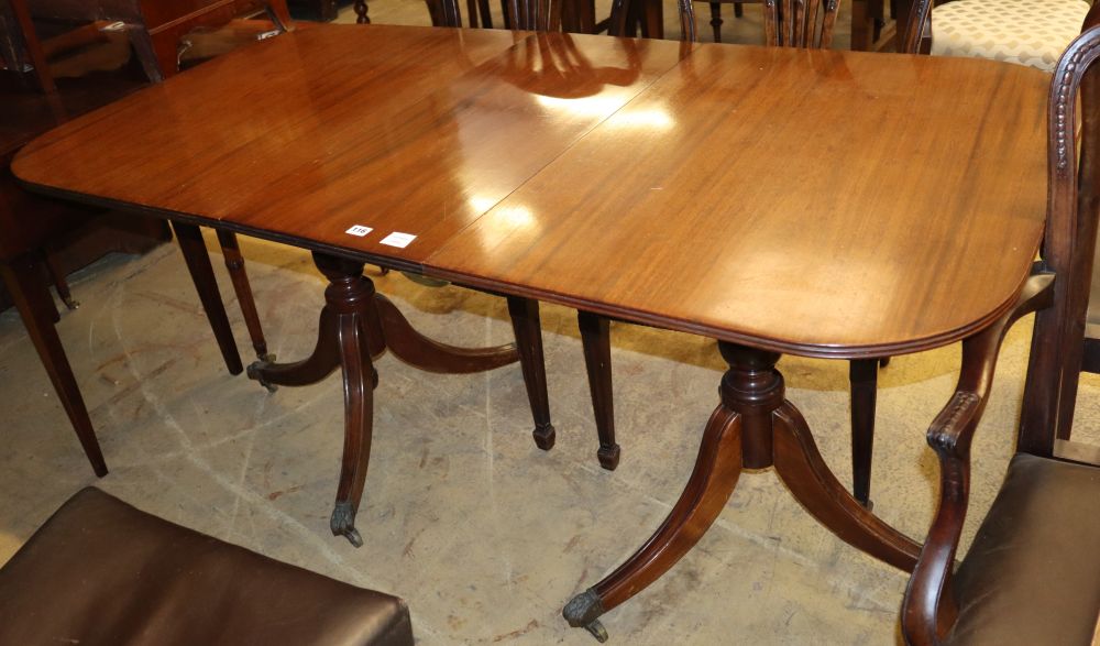 A small Regency design mahogany two pillar dining table, one spare leaf, W.166cm, D.86cm,